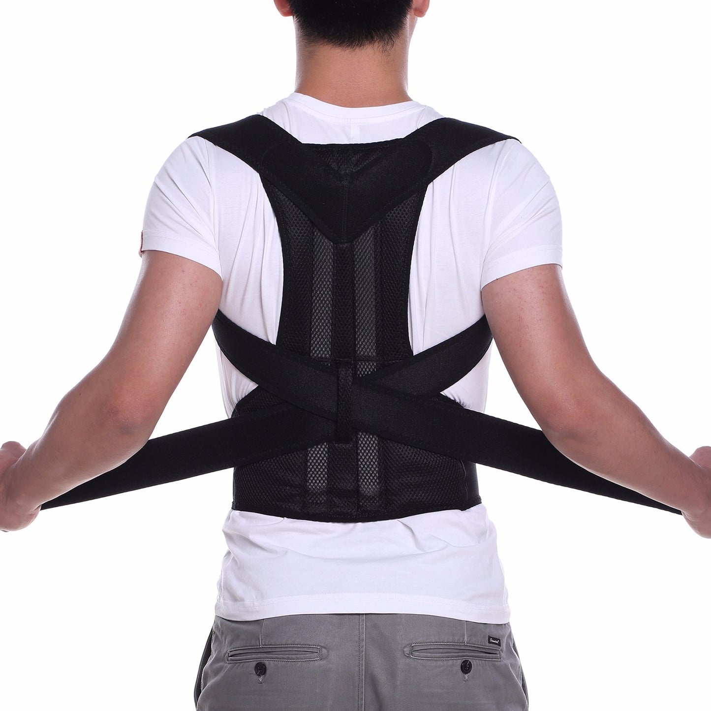 Close-up of a man wearing a black adjustable posture corrector belt over his t-shirt to fix rounded shoulders and hunchback.