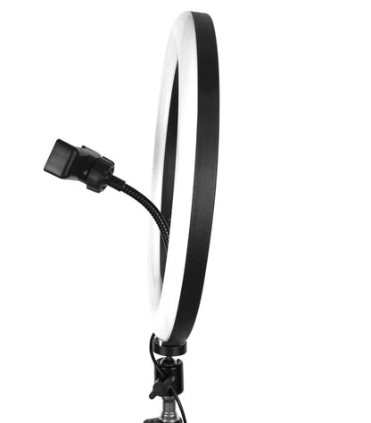 A lifestyle shot of a content creator filming a makeup tutorial using a 13-inch LED ring light with an iPhone mounted in the center holder.