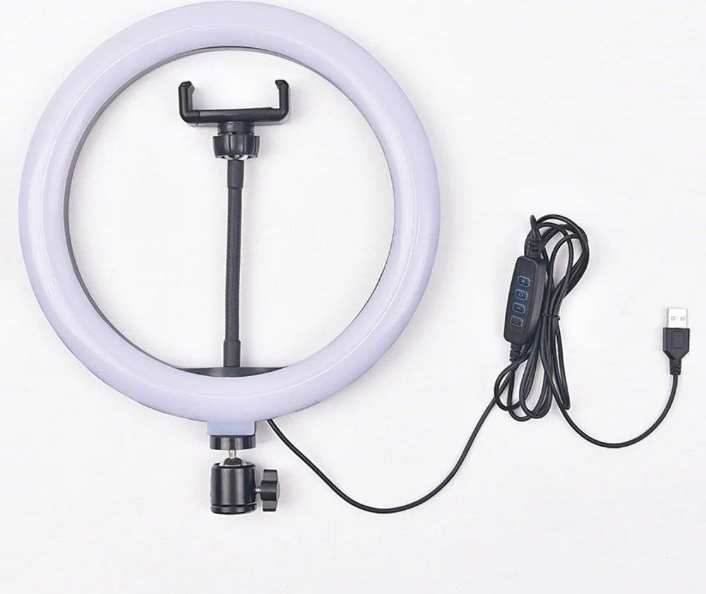 A lifestyle shot of a content creator filming a makeup tutorial using a 10-inch LED ring light with an iPhone mounted in the center holder.