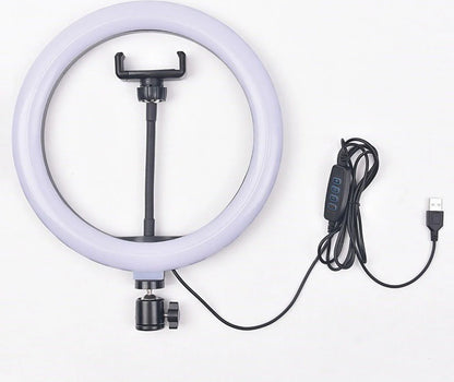A lifestyle shot of a content creator filming a makeup tutorial using a 10-inch LED ring light with an iPhone mounted in the center holder.
