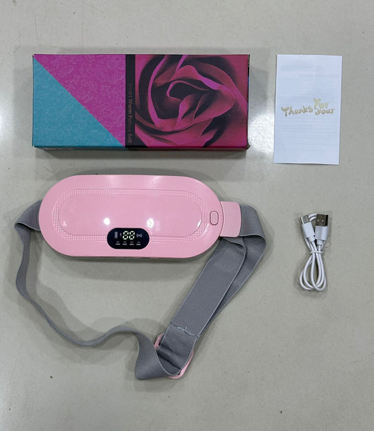 Close-up of a woman wearing a pink cordless menstrual heating pad belt around her waist for lower back and period cramp relief.