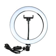 A lifestyle shot of a content creator filming a makeup tutorial using a 11-inch LED ring light with an iPhone mounted in the center holder.